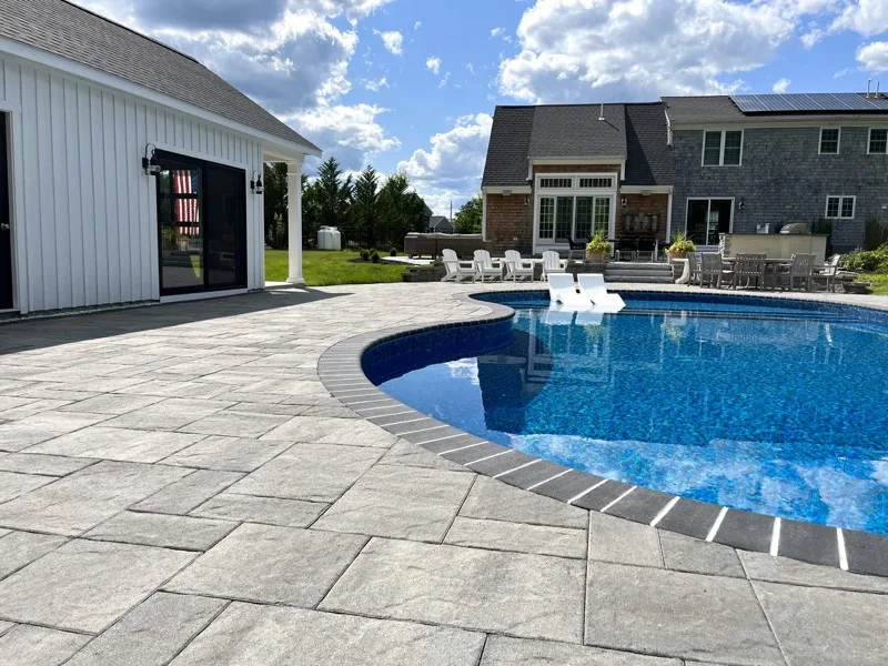 Custom paver pool patio and deck installed by Dellarocco's