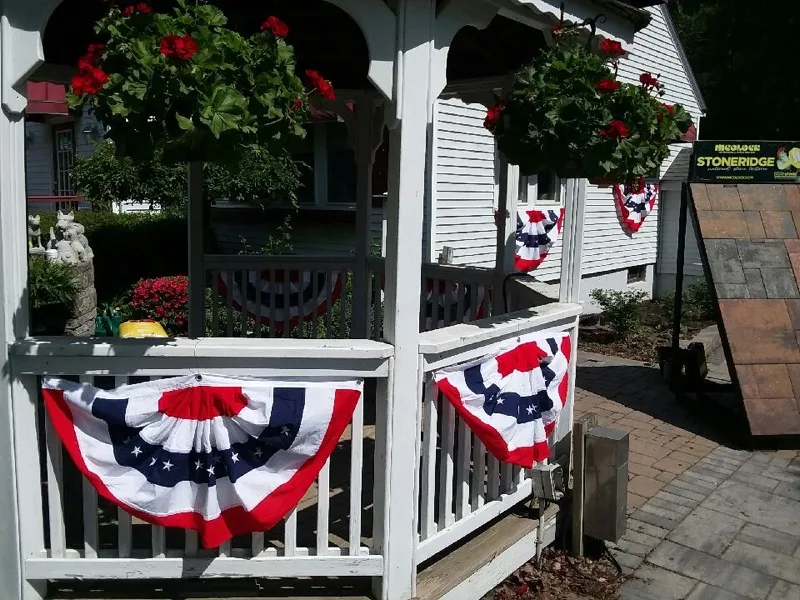 Dellarocco's retail yard entrance with hanging flower baskets and signage